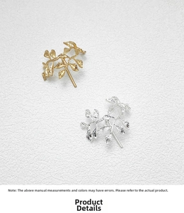 Close-up of gold and silver leaf hair pins showing detailed vein texture on the metal