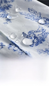 Detailed macro view showing water-repellent floral cotton fabric with droplets