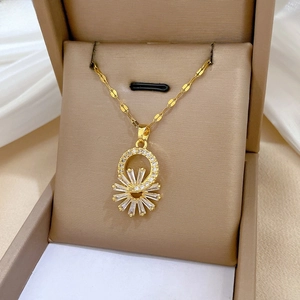 Macro view of gold sunburst flower necklace with zircons on white silk and jewelry box