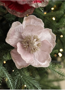 Close-up of pink velvet poinsettia with gold glitter edges on a Christmas tree