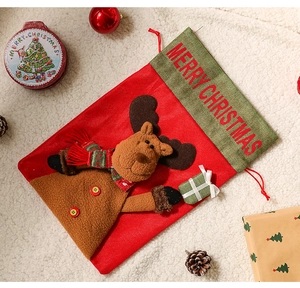Detailed view of linen Christmas stocking with plush reindeer and festive decorations