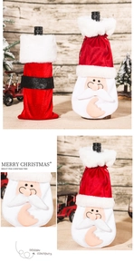 Detail of red velvet Christmas wine bottle covers with Santa motifs and faux fur trim