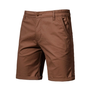 Detail view of men's cargo shorts featuring side pockets and cuffed hem in caramel brown