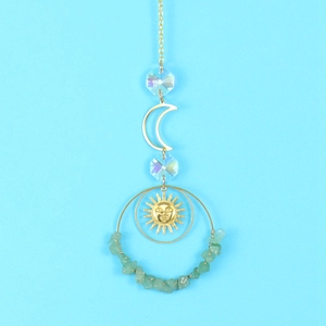 Detail of suncatcher with golden crescent moon, crystal beads and green natural stones