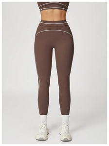 Close-up of high-waisted coffee brown yoga pants with white stitching details