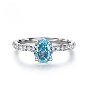 Macro detail of oval blue sapphire silver ring with side-set micro pavé diamonds