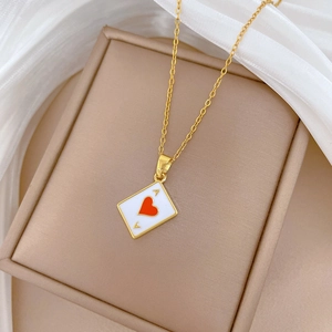 Detail of Ace of Hearts poker pendant necklace with crystals on beige jewelry box