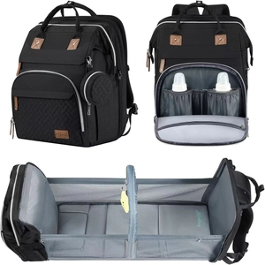 Versatile black diaper bag backpack expanding into a portable baby travel bassinet