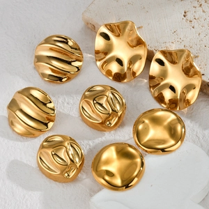 Irregular textured golden stainless steel stud earrings set on a white surface
