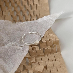 Elegant 925 sterling silver starburst signet ring on textured paper background