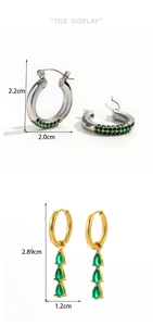 Detailed size display of geometric drop earrings with green stones and sparkling pavé crystals