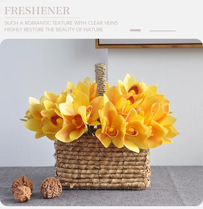 Detailed macro view of 3D printed yellow Cymbidium orchids in a rustic straw woven basket