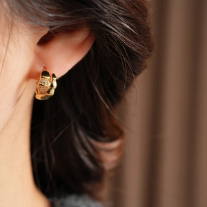 Close-up of a 14K gold plated serpent hoop earring set with sparkling zircon stones