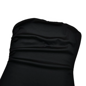 Detailed macro view of the ruched black fabric with elegant pleated texture on the dress