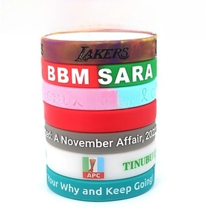 Detailed view of various custom silicone wristbands with multi-color printing and embossed logos