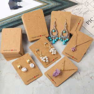 Brown kraft paper jewelry display cards with Handmade with love print on marble background