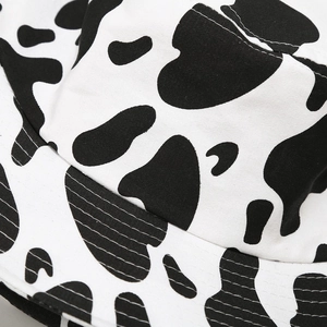 Close-up of cow print bucket hat showing fabric texture and reinforced stitching