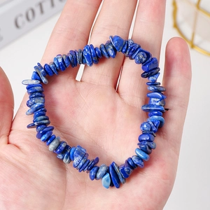 Lapis Lazuli crystal chip bracelet held by hand, natural deep blue stone jewelry