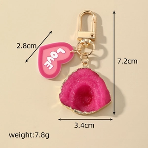 Detail showing the 7.2cm height and 3.4cm width of the resin heart love keychain
