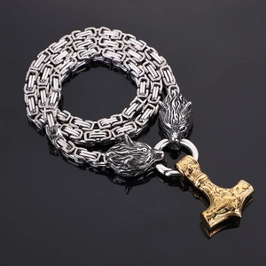Detailed view of silver and black Byzantine chain with golden Mjolnir Thor's Hammer pendant