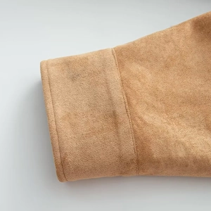 Detail view of camel faux suede jacket showing high-quality cuff and fabric texture
