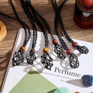 Handmade woven net pouch necklaces with colorful wooden beads on a rustic wooden table