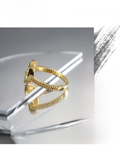 Detailed close-up of a gold vintage ring with micro-set yellow zircons on a mirror base