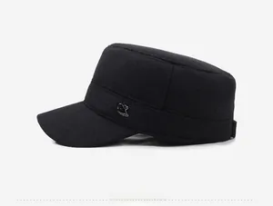 Detail view of winter flat top military cap featuring a metal R logo and warm fabric