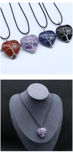 Close-up of heart crystal pendant with tree of life wire wrap on model necklace