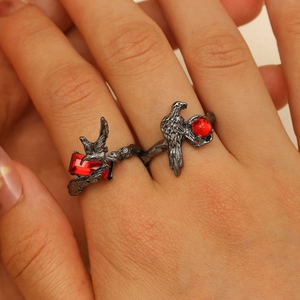 Gothic raven ring detail with vintage black finish and vibrant red crystal accents