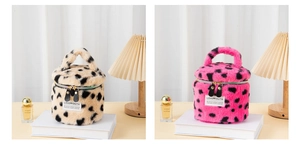Detail of plush cylinder cosmetic bags in beige and pink leopard print with gold zippers