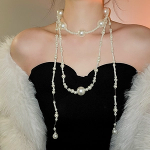 Close-up of elegant multi-layer pearl necklace with varying sizes of white pearls
