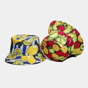 Detail of summer bucket hats with lemon stripes and fruit patterns in breathable cotton