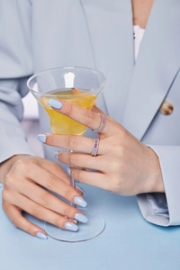 Close-up of S925 silver rings with colorful cubic zirconia worn by a model