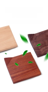 Detailed view of square wooden coasters in natural, reddish, and dark walnut finishes