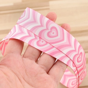 Close-up of pink heart-pattern polyester lanyard with durable plastic ID card holder
