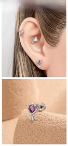 Macro detail of bouquet-shaped stud earrings with heart-cut purple and pink zircon stones