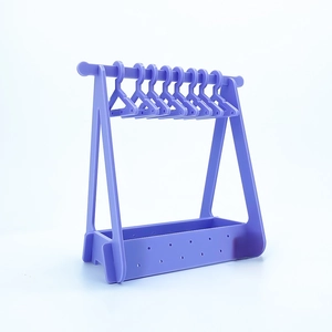 Macro shot of light purple acrylic earring organizer with 10 mini clothes hanger hooks