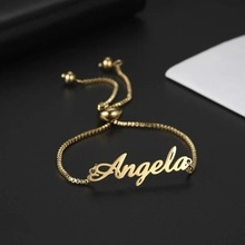 Detailed view of adjustable golden name bracelet featuring a custom Angela script pendant