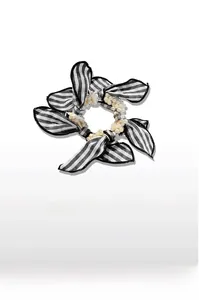 Detail of checkered bow hair tie featuring elegant faux pearl bead embellishments