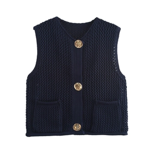 Detail of navy knit vest with textured stitch pattern and vintage gold buttons