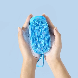 Blue silicone shower brush with massage bristles and rich foam for deep body exfoliation