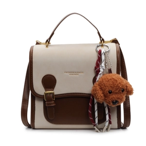 Chic two-tone cream and brown crossbody backpack with a cute teddy bear charm