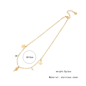 Detailed view of golden stainless steel necklace with starfish, shell, and pearl charms