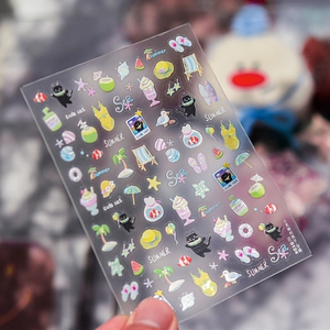 Close-up of summer ocean theme embossed stickers featuring black cat and beach elements