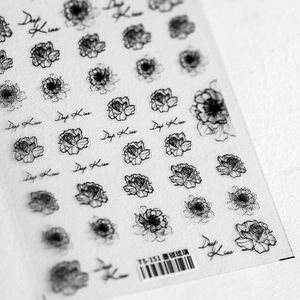 Detailed macro view of black vintage rose nail stickers with Deep Kiss cursive text