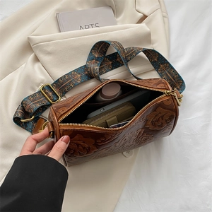 Top view of open retro cylinder bag showing internal space for phone and wallet