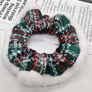 Close-up of Christmas scrunchie with red and green plaid fabric and white plush trim