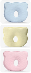 Detailed view of bear-shaped baby memory foam pillows in blue, yellow, and pink colors