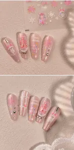 Detail of pink winter nail stickers featuring snow, bows, and crystals in M-830 style